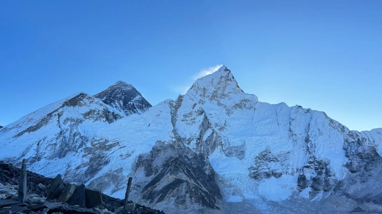 Snow-covered high Himalayan peaks under a deep blue sky on the route to Everest Base Camp